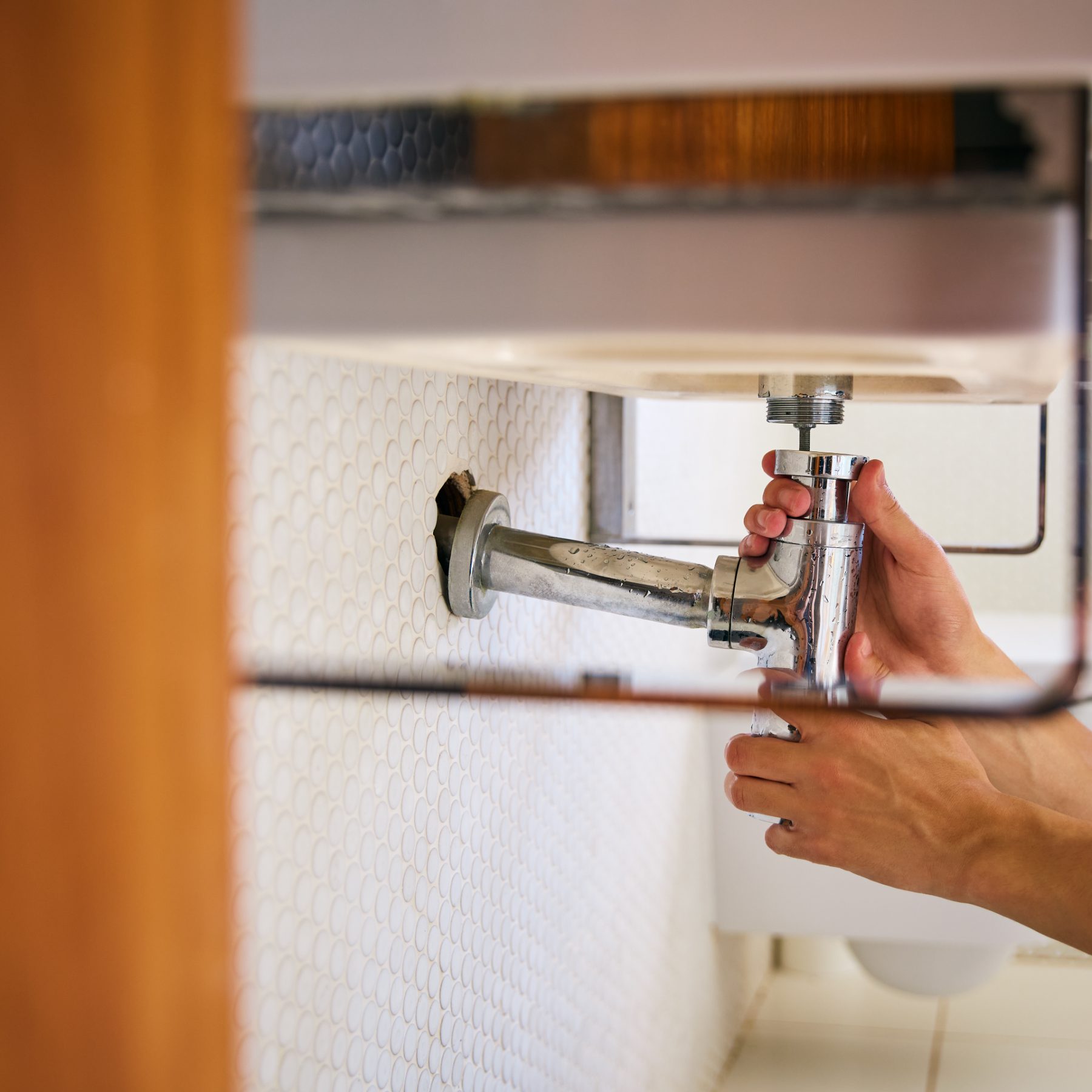 Plumber fixing a leak.
